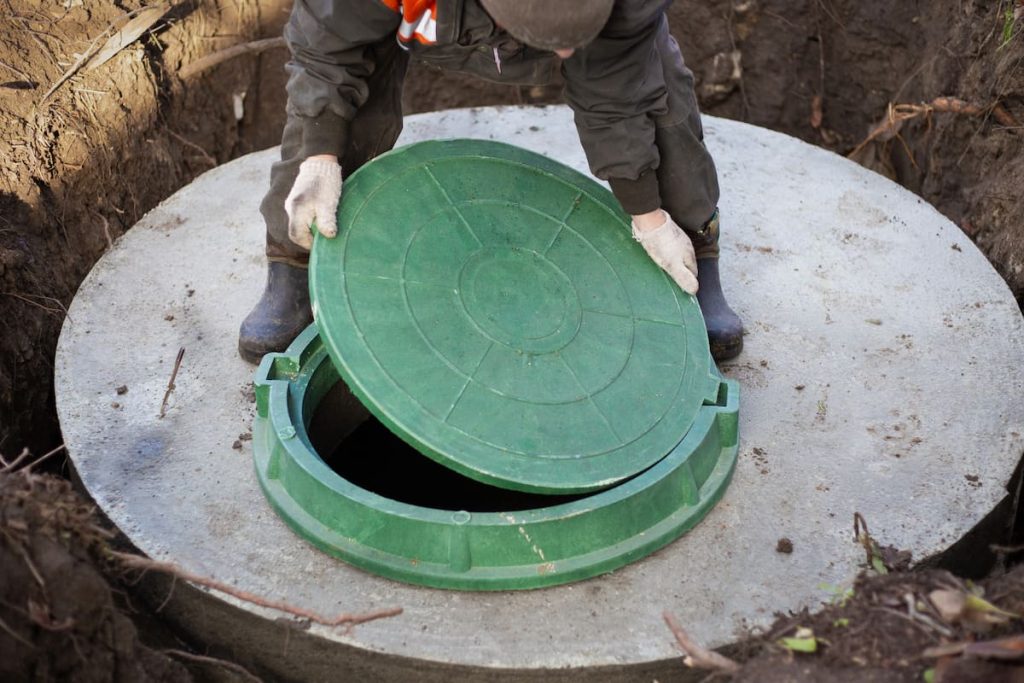 Close-up of a septic tank access lid used for inspection and maintenance.