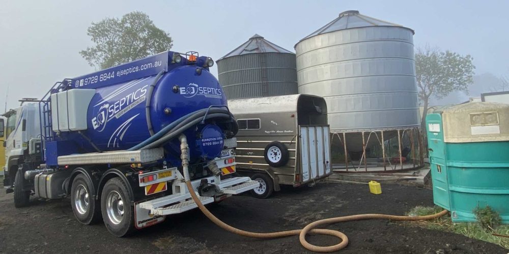 Septic truck pumping wastewater from septic tanks on a rural Warragul property.